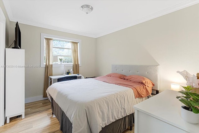 bedroom featuring light hardwood / wood-style floors and ornamental molding