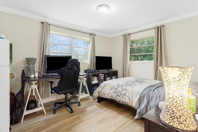 bedroom with light hardwood / wood-style flooring and crown molding