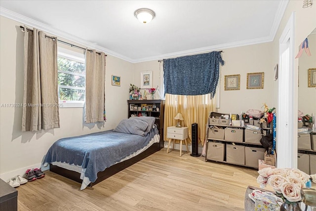 bedroom with ornamental molding and light hardwood / wood-style flooring