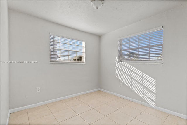 unfurnished room featuring light tile patterned floors