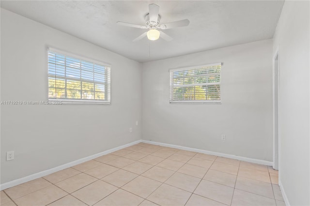 unfurnished room with ceiling fan and light tile patterned floors