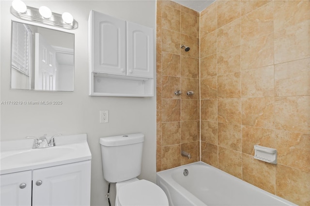 full bathroom with toilet, vanity, and tiled shower / bath