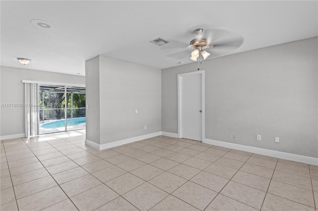 unfurnished room with ceiling fan and light tile patterned flooring