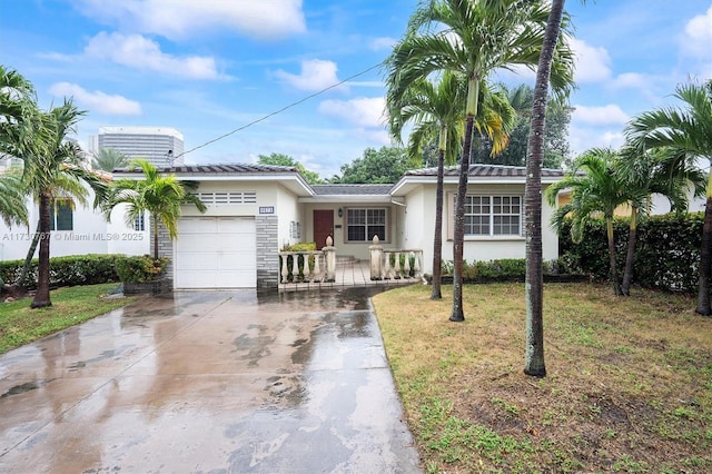 ranch-style house featuring a garage, a front yard, and central AC