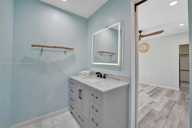 bathroom featuring vanity, hardwood / wood-style flooring, and ceiling fan