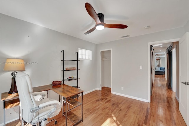 office space featuring ceiling fan and light wood-type flooring