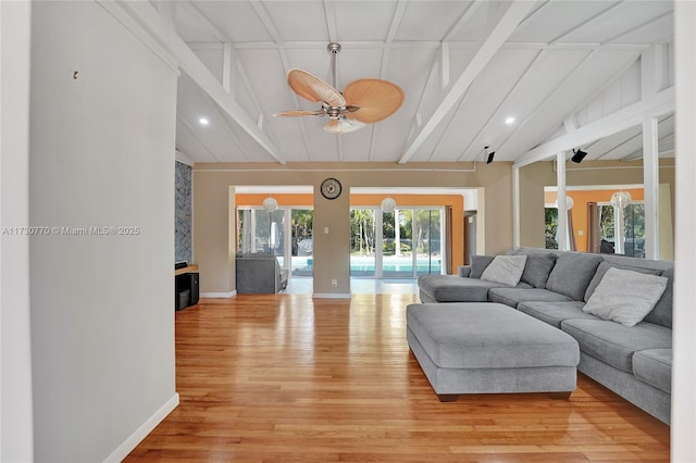 living room with vaulted ceiling with beams, ceiling fan, and light wood-type flooring