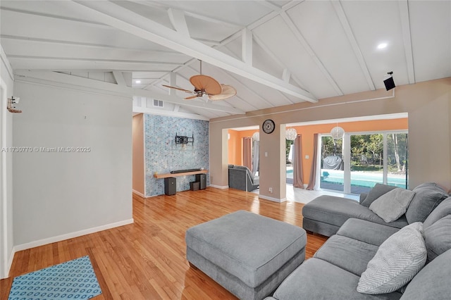 living room featuring lofted ceiling with beams, hardwood / wood-style floors, and ceiling fan