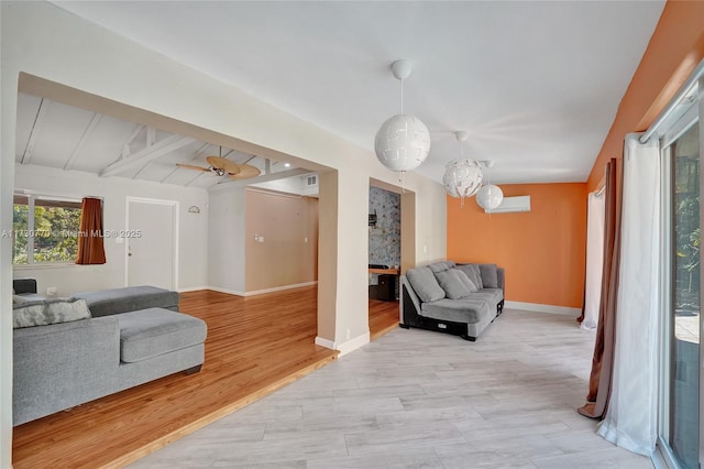 interior space featuring beamed ceiling, ceiling fan, and light hardwood / wood-style flooring