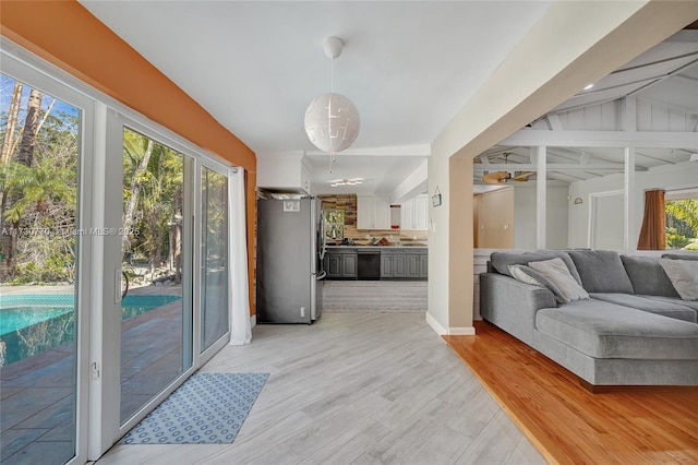 living room with vaulted ceiling and light hardwood / wood-style floors