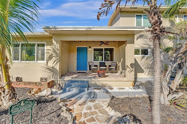 doorway to property featuring ceiling fan