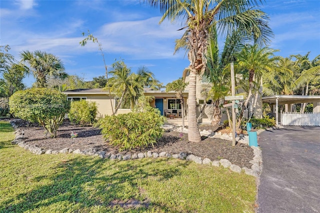 view of front of house with a front yard and a carport