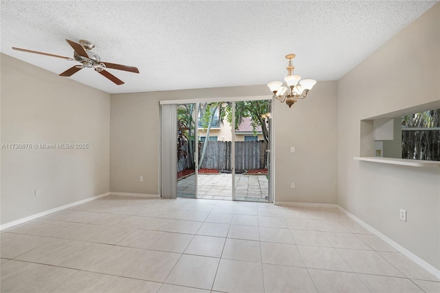 spare room with light tile patterned floors, ceiling fan with notable chandelier, and a textured ceiling