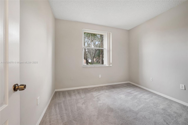 spare room with carpet floors and a textured ceiling