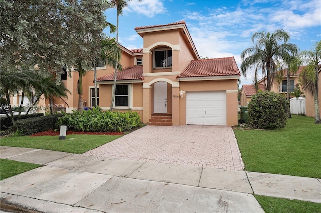 mediterranean / spanish-style house with a garage and a front yard