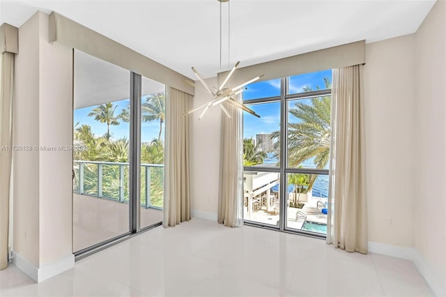 entryway with light tile patterned flooring and a water view