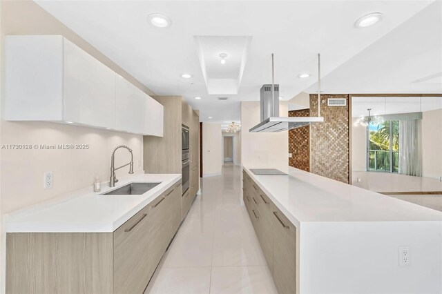 kitchen featuring hanging light fixtures, sink, island exhaust hood, light tile patterned floors, and black appliances