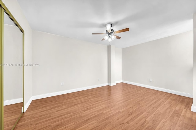 spare room with light wood-type flooring and ceiling fan