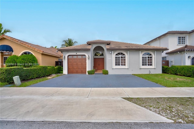 mediterranean / spanish-style house with a garage