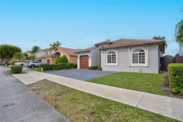 view of front of home with a garage and a front yard