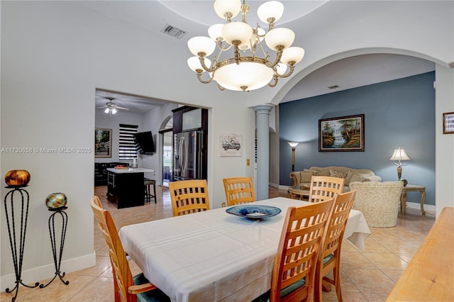 tiled dining area with decorative columns and ceiling fan with notable chandelier