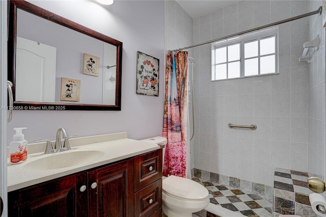 bathroom featuring curtained shower, toilet, and vanity