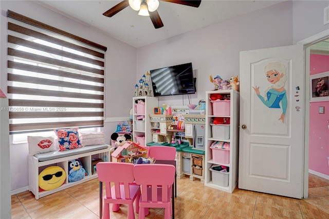 game room with ceiling fan and light tile patterned flooring