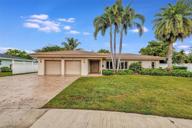 single story home with a garage and a front lawn