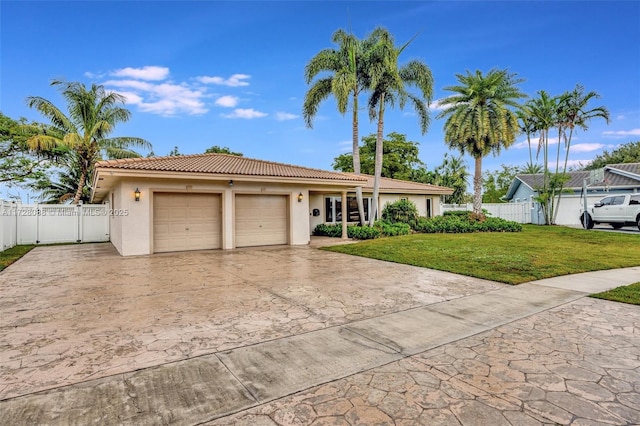 view of front of house with a garage and a front yard