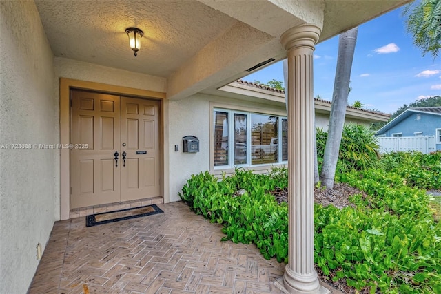 doorway to property featuring stucco siding