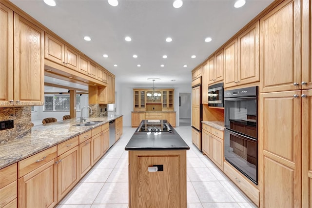 kitchen with a sink, black appliances, light tile patterned flooring, and light brown cabinetry
