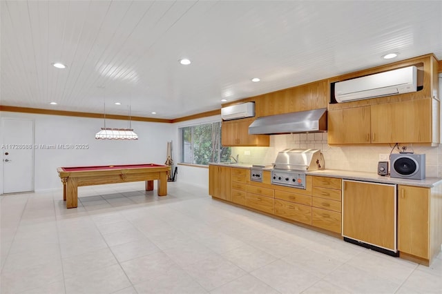 kitchen featuring backsplash, a wall unit AC, wall chimney range hood, and fridge
