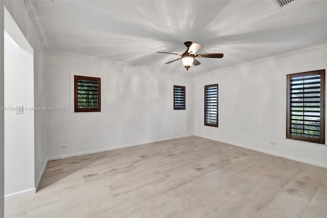 spare room featuring crown molding, wood finished floors, and ceiling fan