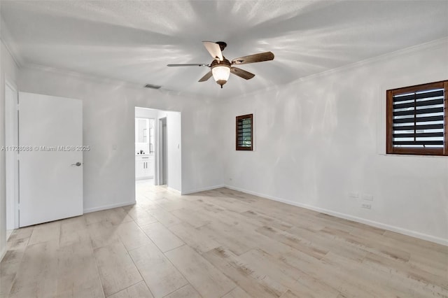 empty room with light wood-style flooring, ceiling fan, and ornamental molding
