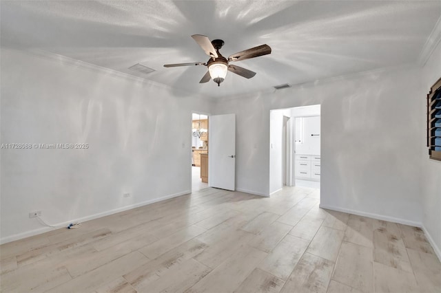 empty room featuring visible vents, ornamental molding, light wood-style flooring, and ceiling fan