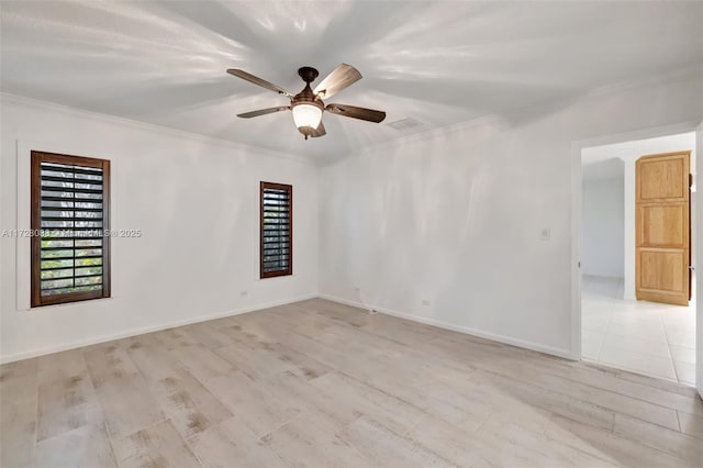 unfurnished room with baseboards, light wood-style flooring, a ceiling fan, crown molding, and visible vents