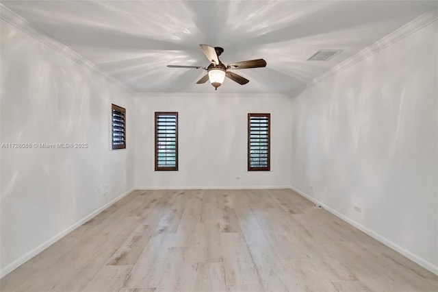 spare room featuring crown molding, a ceiling fan, visible vents, wood finished floors, and baseboards
