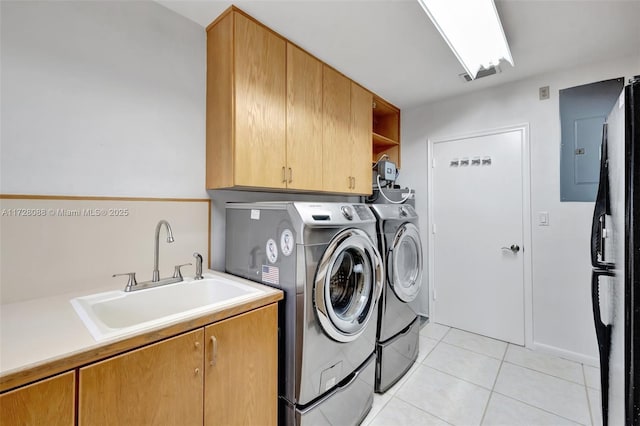 clothes washing area featuring light tile patterned floors, electric panel, a sink, cabinet space, and washing machine and dryer