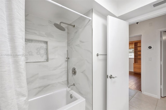 bathroom featuring tile patterned floors, shower / tub combo, and visible vents