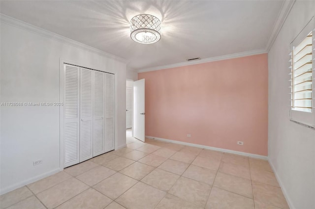 unfurnished bedroom featuring crown molding, light tile patterned flooring, baseboards, and visible vents