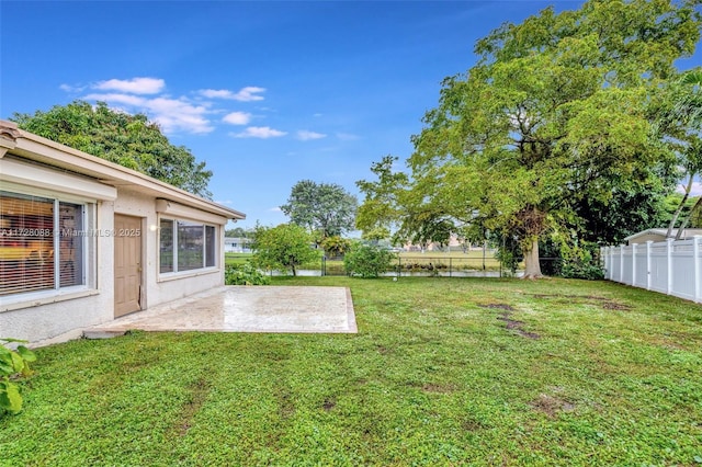 view of yard featuring a patio area and fence