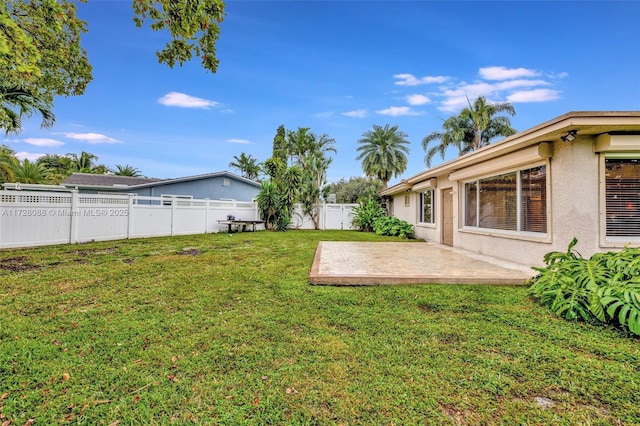 view of yard with a patio area and a fenced backyard