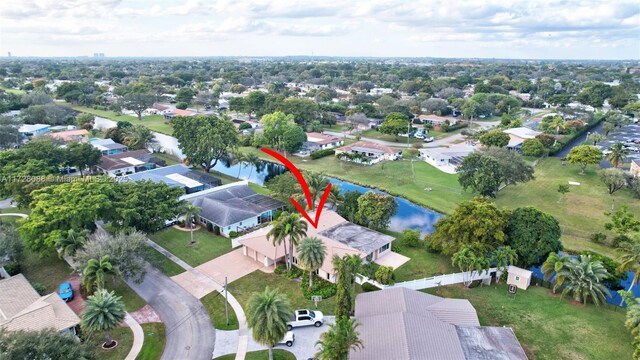 birds eye view of property featuring a water view and a residential view