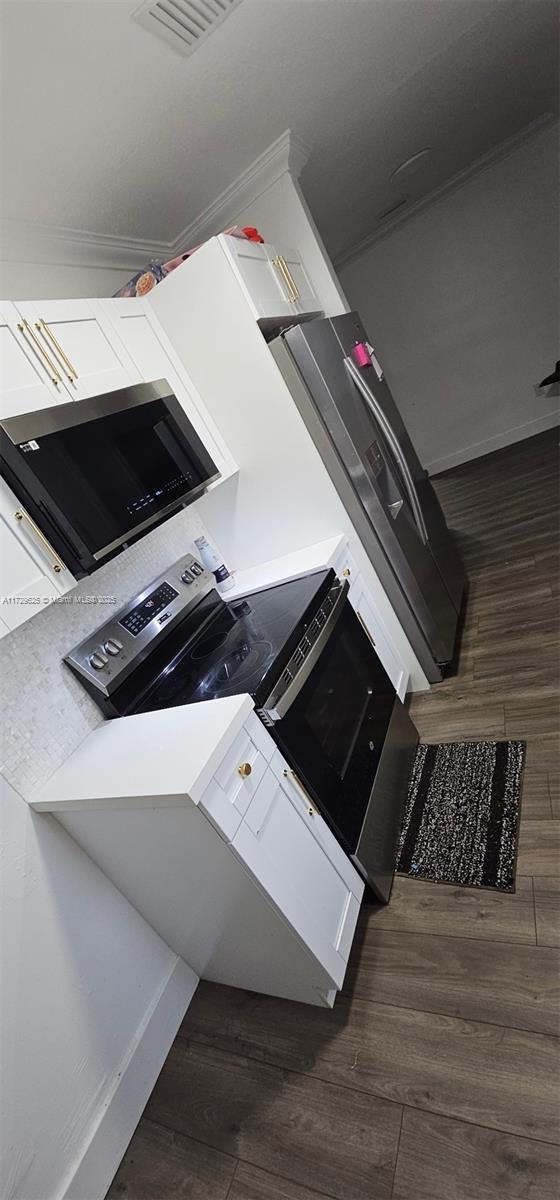 kitchen with crown molding and white cabinets