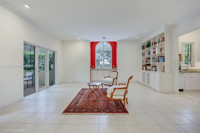 living area featuring sink, built in shelves, ornamental molding, and light tile patterned floors