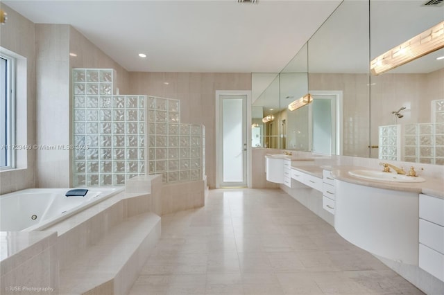 bathroom with vanity, shower with separate bathtub, tile walls, and tile patterned flooring