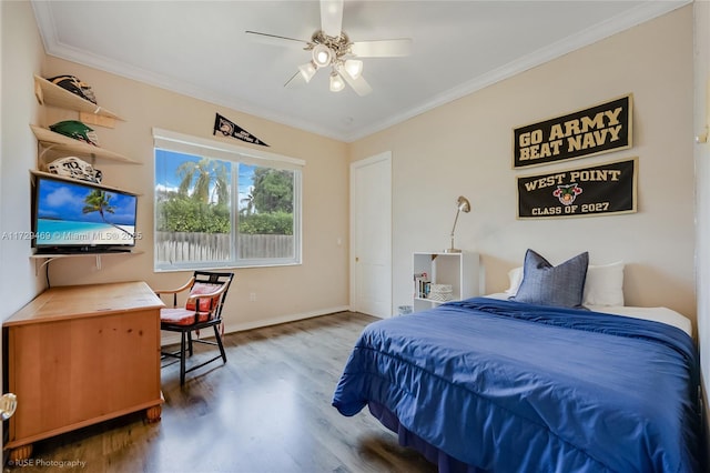 bedroom featuring ceiling fan, hardwood / wood-style floors, and crown molding