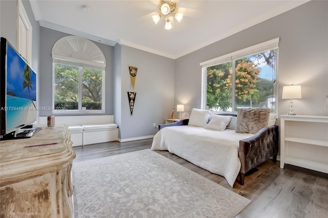 bedroom with hardwood / wood-style floors, multiple windows, and ceiling fan