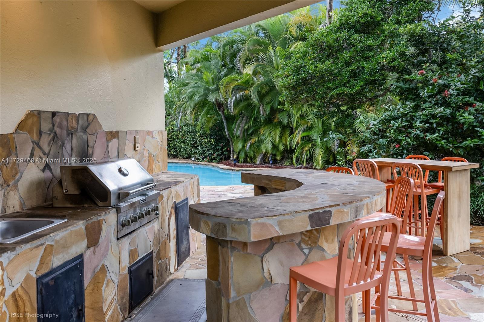 view of patio / terrace featuring area for grilling, exterior kitchen, and an outdoor bar