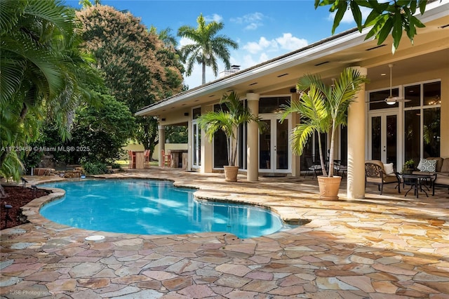 view of pool featuring french doors and a patio area